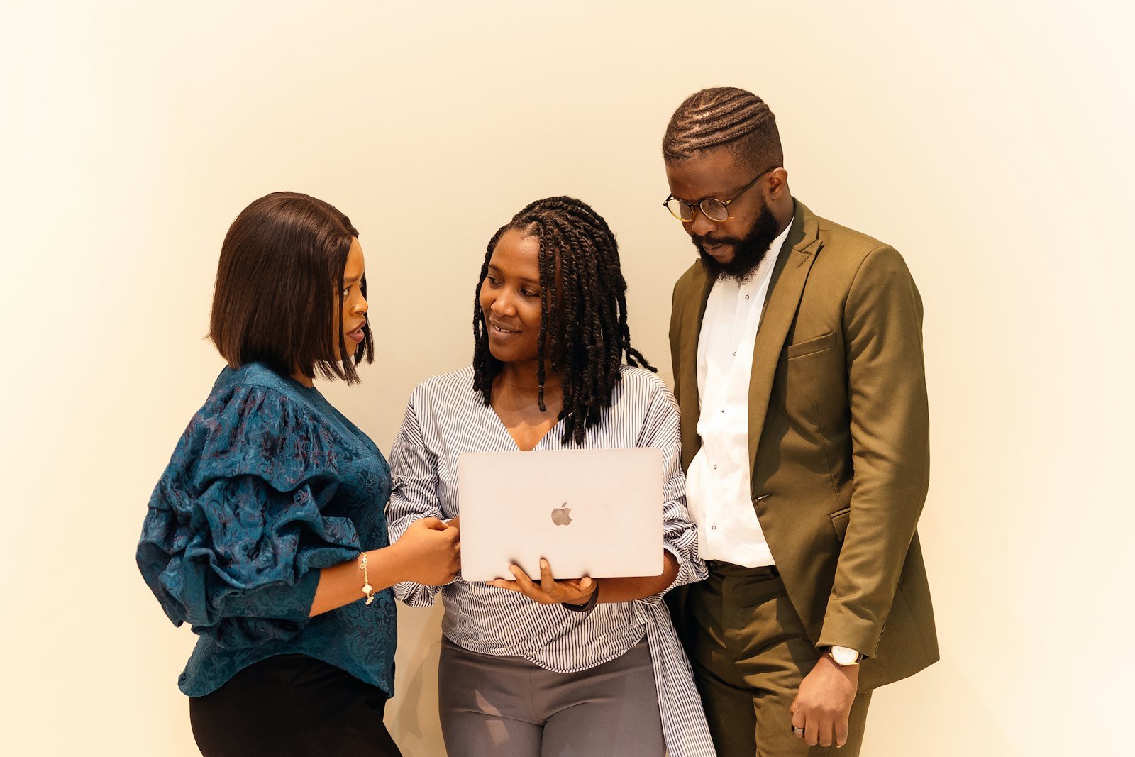 Three colleagues looking at a laptop together